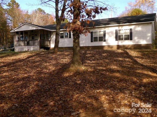 rear view of property featuring a porch