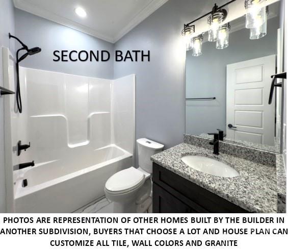 full bathroom featuring vanity, toilet, crown molding, and bathing tub / shower combination