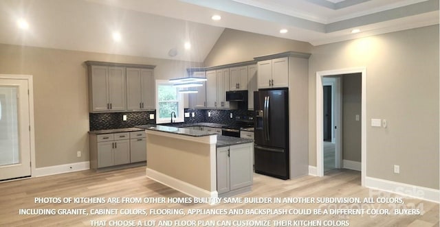 kitchen with light hardwood / wood-style flooring, gray cabinets, a kitchen island, and black appliances