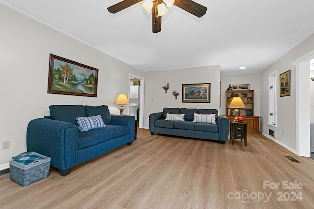 living room with ceiling fan and light hardwood / wood-style flooring