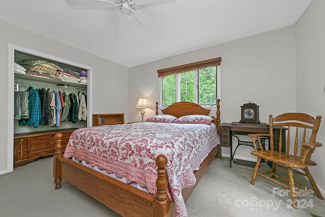 carpeted bedroom featuring ceiling fan and a closet