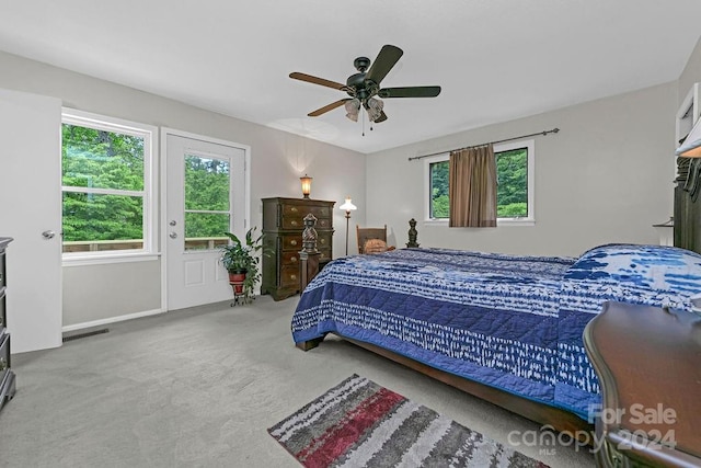 carpeted bedroom featuring ceiling fan and multiple windows