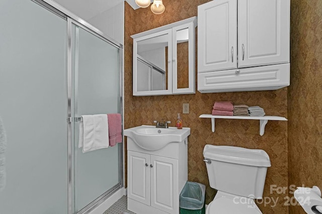 bathroom with toilet, vanity, and walk in shower