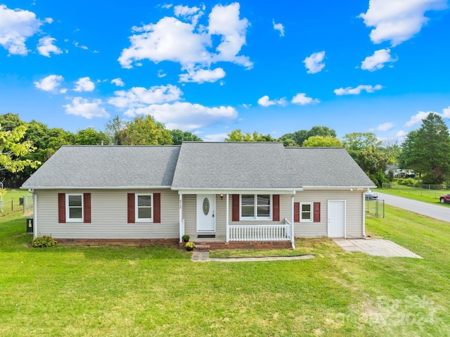 ranch-style home with a porch, a garage, and a front lawn