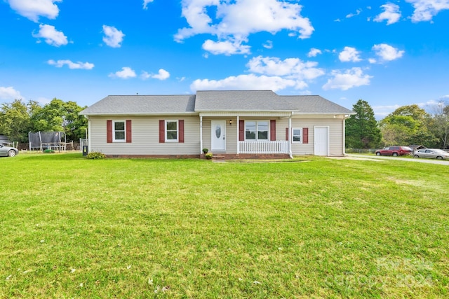 view of front of house with a front lawn, covered porch, and a trampoline