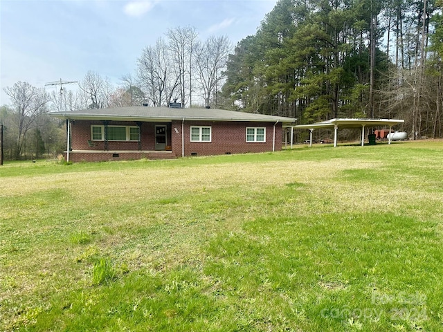 ranch-style house featuring a carport and a front yard