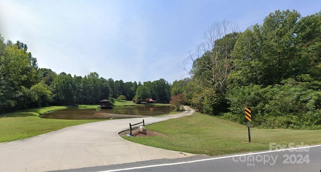 view of property's community featuring a water view and a lawn