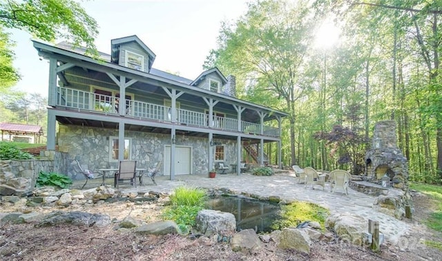 rear view of house with a balcony and a patio area