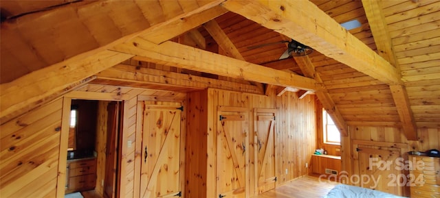 bonus room featuring wood ceiling, lofted ceiling with beams, wood walls, and light wood-type flooring