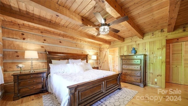 bedroom featuring wooden walls, wooden ceiling, and light wood-type flooring