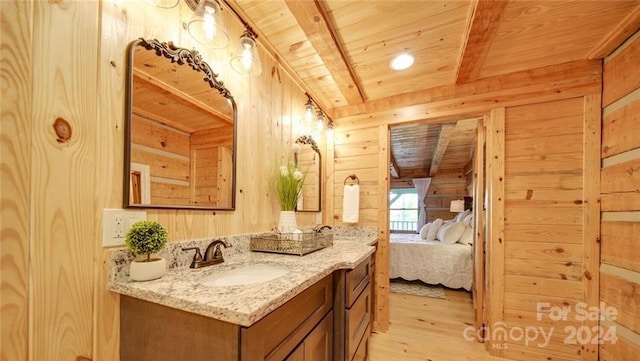 bathroom with vanity, hardwood / wood-style floors, beam ceiling, wooden walls, and wood ceiling