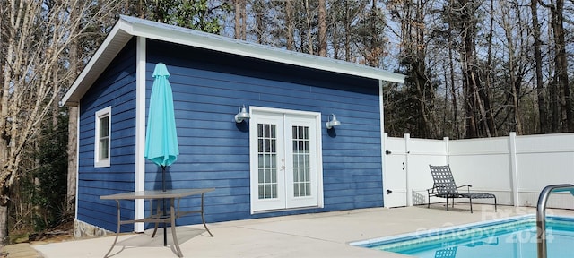 view of shed / structure featuring french doors and a fenced in pool