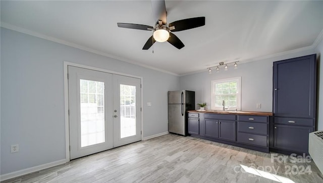 interior space with ceiling fan, french doors, ornamental molding, light wood-type flooring, and track lighting