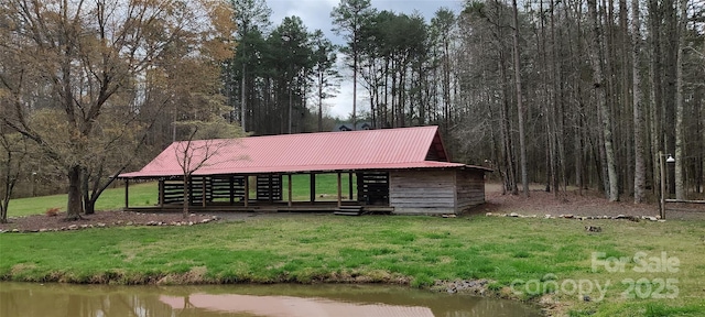 view of front facade with a water view and a front yard