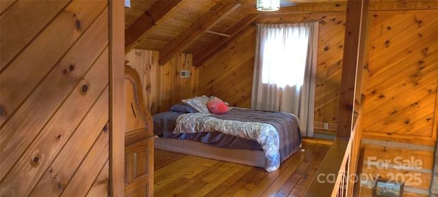 bedroom featuring hardwood / wood-style flooring, wood ceiling, wooden walls, and vaulted ceiling with beams