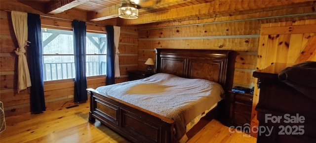 bedroom featuring wooden ceiling, beam ceiling, light wood-type flooring, and wood walls