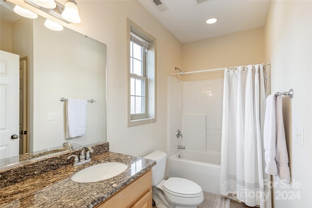 full bathroom featuring shower / bathtub combination with curtain, toilet, and vanity