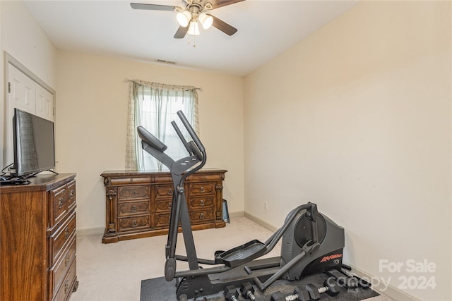 exercise area with ceiling fan and light carpet