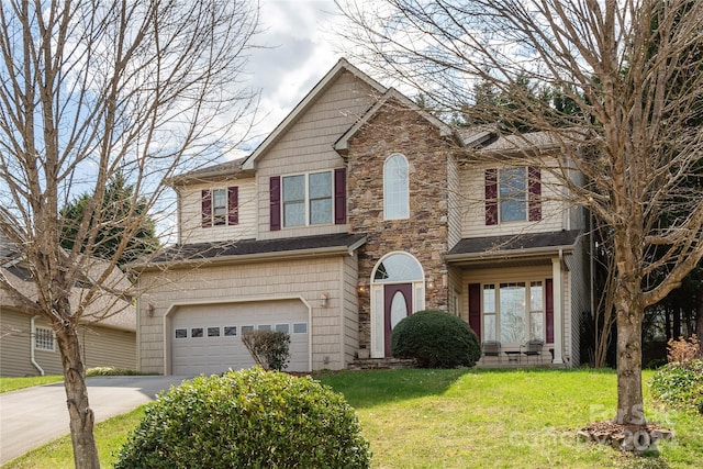 view of front of home with a front lawn and a garage