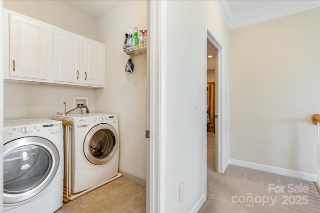 laundry room with cabinet space, baseboards, ornamental molding, and separate washer and dryer