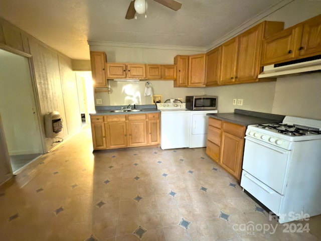 kitchen featuring white range with gas stovetop, crown molding, washer and clothes dryer, and ceiling fan