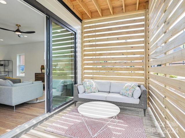 balcony with an outdoor living space and ceiling fan