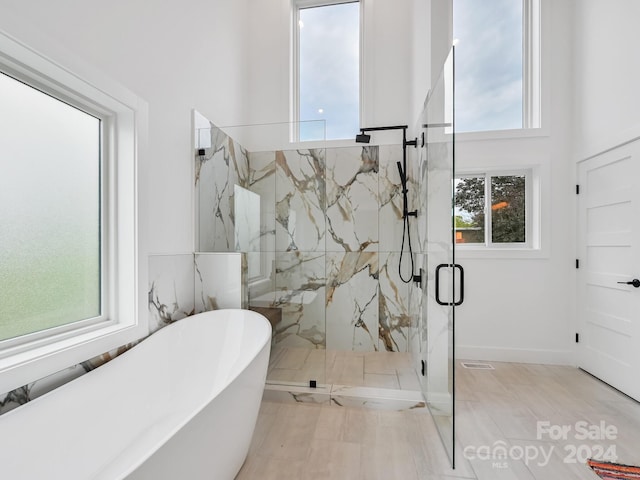 bathroom with plenty of natural light, tile floors, and shower with separate bathtub