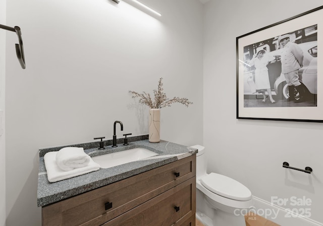 bathroom featuring vanity and toilet