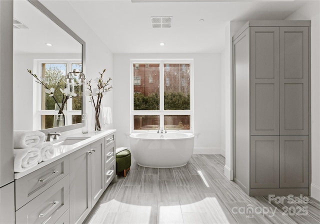 bathroom with a bath and vanity