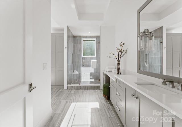 bathroom with vanity and a shower with door