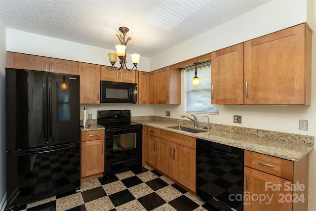 kitchen featuring black appliances, an inviting chandelier, sink, and a textured ceiling