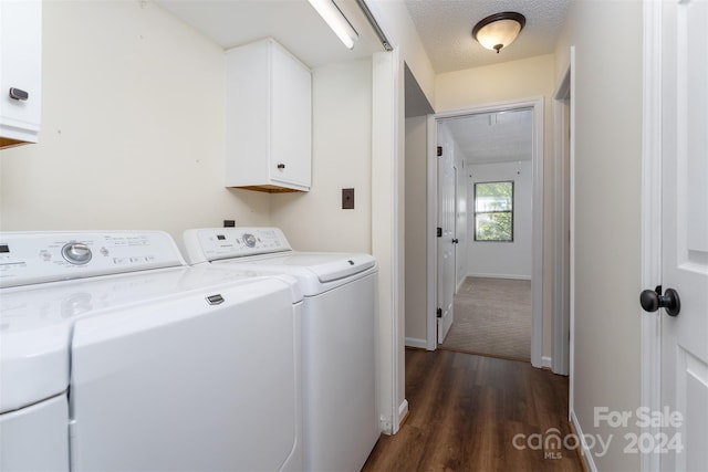 laundry room with dark wood-type flooring, cabinets, a textured ceiling, and independent washer and dryer