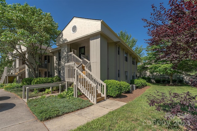 exterior space with a yard and cooling unit