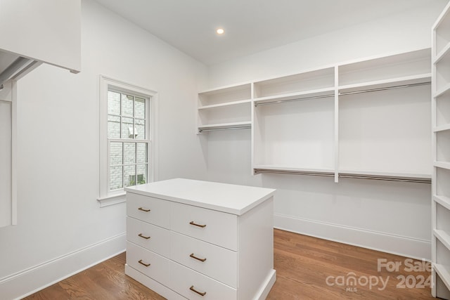 walk in closet with hardwood / wood-style floors