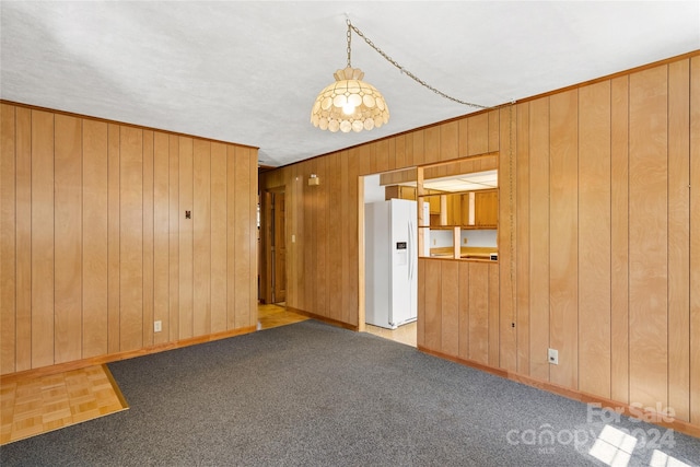 carpeted empty room with wooden walls