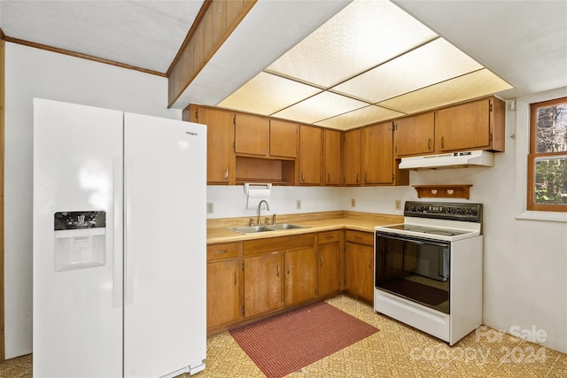 kitchen featuring light tile flooring, sink, and white appliances