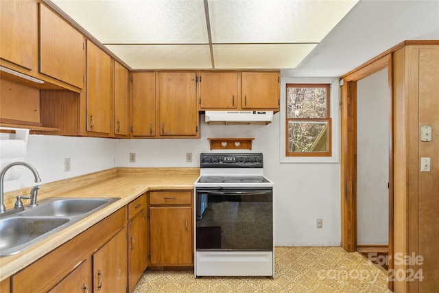 kitchen featuring sink, electric stove, and light tile flooring