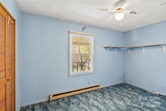 empty room with dark carpet, a baseboard radiator, and ceiling fan