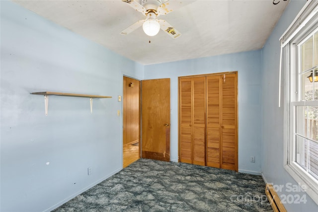 unfurnished bedroom featuring ceiling fan, a closet, carpet floors, and multiple windows