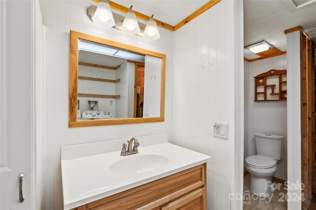 bathroom featuring tile floors, toilet, a textured ceiling, and vanity