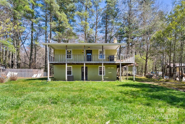 back of house with a deck, a yard, and central air condition unit