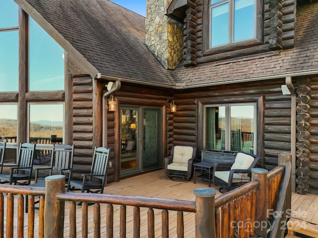 exterior space featuring an outdoor hangout area and a wooden deck