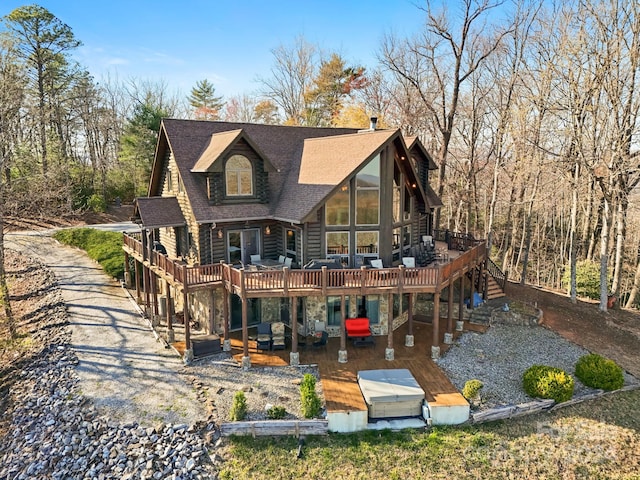 back of property featuring a deck and a patio