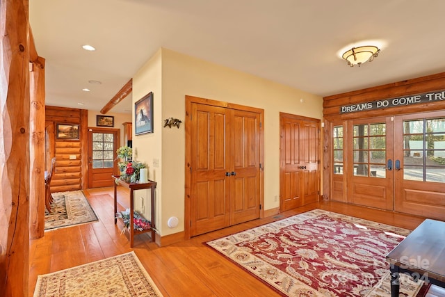 entrance foyer with light hardwood / wood-style floors and french doors