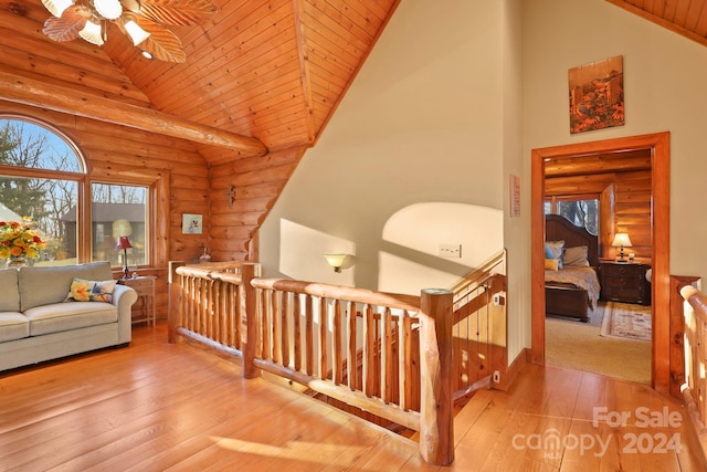 corridor featuring rustic walls, high vaulted ceiling, wood ceiling, and light wood-type flooring