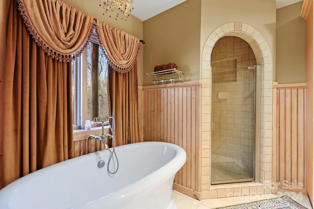 bathroom featuring tile floors, a wealth of natural light, and separate shower and tub