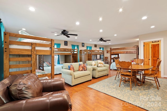 living room featuring ceiling fan and light hardwood / wood-style flooring