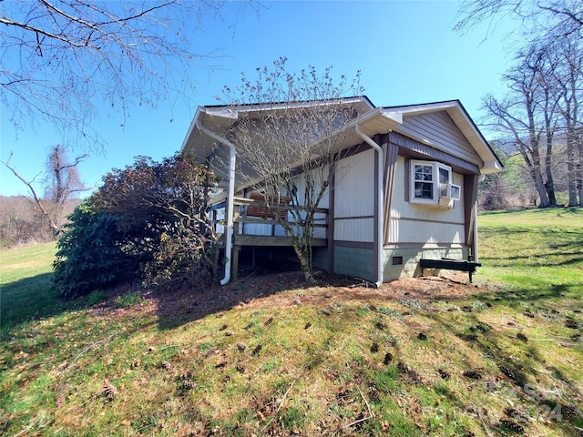 view of side of home featuring a lawn and a wooden deck