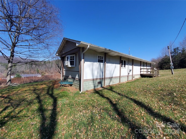 view of side of property with a lawn