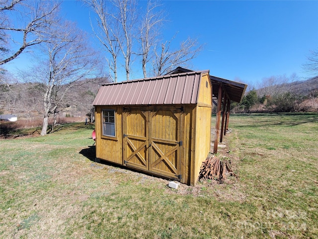 view of outdoor structure featuring a lawn